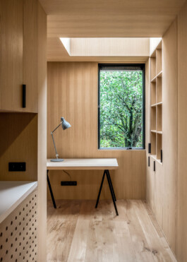 Wooden interior of the Tree House extension. Working desk with a window to the garden in Amsterdam. Designed by Ivo Jelinek from IJarchitecture.