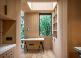 Wooden interior of the Tree House extension. View at the working desk with a window to the garden in Amsterdam. Designed by Ivo Jelinek from IJarchitecture.