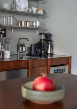 Coffee preparation area with a stainless steel top and wooden base, designed by IJarchitecture's founder Ivo Jelinek, photo by Irena Mila.