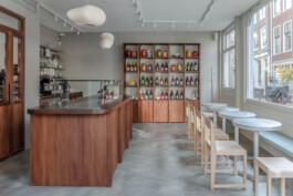 Interior of Saint-Jean Deli in Amsterdam, featuring minimalist wooden furniture and a color palette inspired by Scandinavian aesthetics. The bakery is designed by architect Ivo Jelinek from Amsterdam based studio IJarchitecture.
