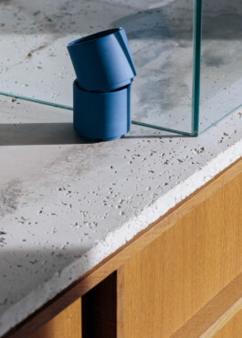 Detail of concrete countertop meeting wood base and glass partition at Saint-Jean bakery, designed by IJarchitecture. 
