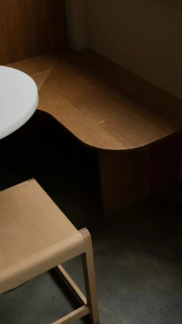 Oak seating area with the Frana table and chair at Saint-Jean Deli in Amsterdam, designed by Ivo Jelinek, IJarchitecture. 