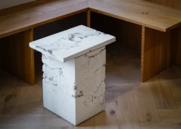 Geometric white concrete bespoke table beside oak bench seating in Saint-Jean Bakery, Amsterdam, designed by IJarchitecture. 