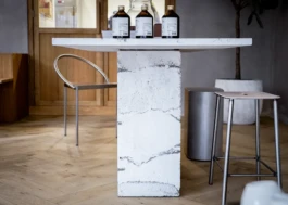White concrete display table in the interior of Saint-Jean Bakery in Amsterdam by IJarchitecture. 