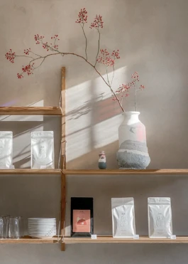 FRAMA shelf with products and ceramics on a clay plaster wall at Saint-Jean Bakery in Amsterdam by IJarchitecture. 