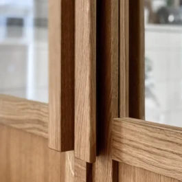 Detail of bespoke oak door and timber frame at Saint-Jean Bakery in Amsterdam by IJarchitecture. 